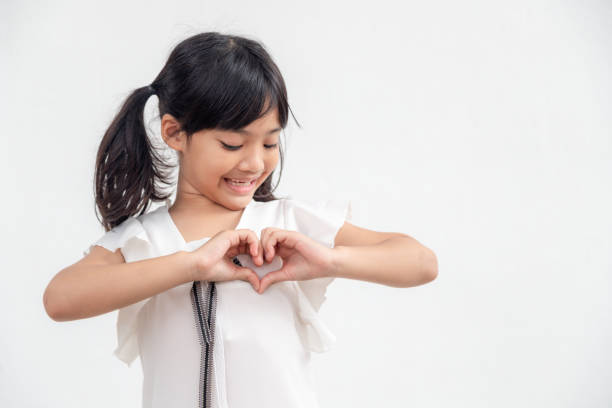 istock Little girl hands making a heart shape on white background 1343448964