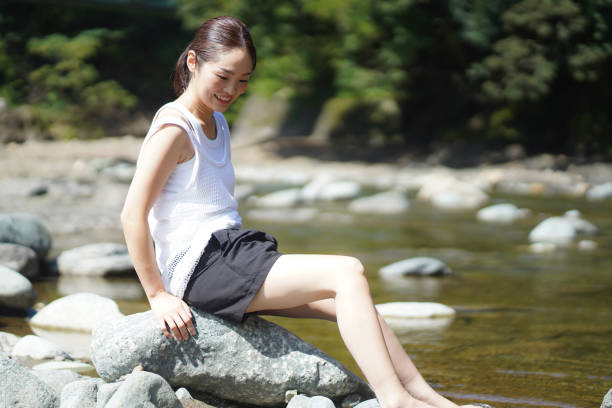 istock Woman stepping into the river 1343450102