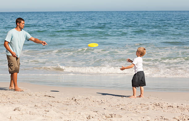 istock Little boy playing frisbee with his father 134345075