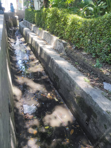 istock Dirty drain canal - Stock Photos. 1343451389