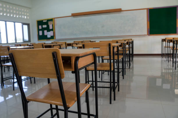 istock School Closed, Empty Classroom whiteboard without children and teacher. College empty class room no childrens when COVID-19 disease outbreak closed quarantine, Education learning problem in world 1343452981