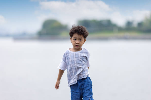 Asian Boys play by the lake