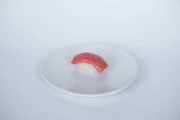 istock Sushi Nigiri with raw tuna served on white plate. 1343457548