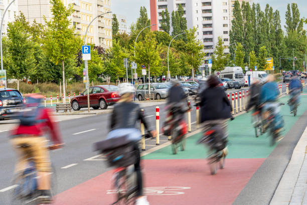 Group of bike riders commuting on a bicycle lane in the city.