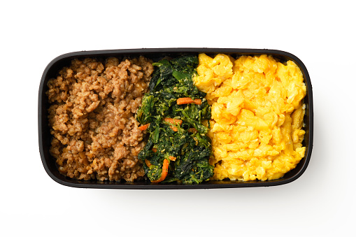Three-colors homemade bento (box lunch) of ground meat, vegetable and scrambled eggs.