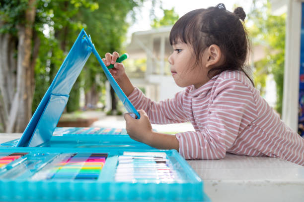 istock Little kids drawing with a colored pencil is a good activity for improving creative art and handwriting skills in children. Concept picture for education and learning hobby. 1343461372