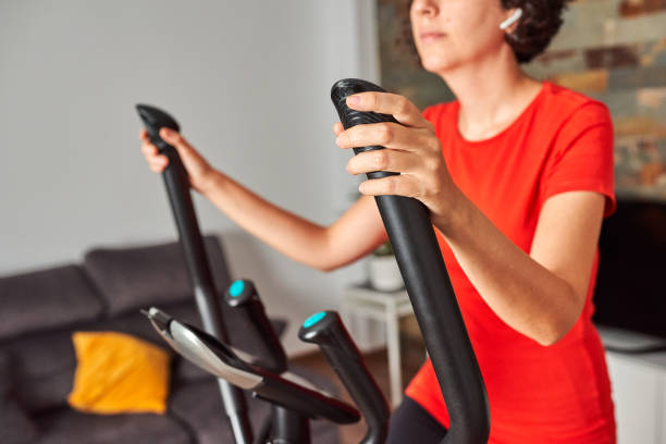 istock Unrecognizable woman training at home using the elliptical trainer 1343463518