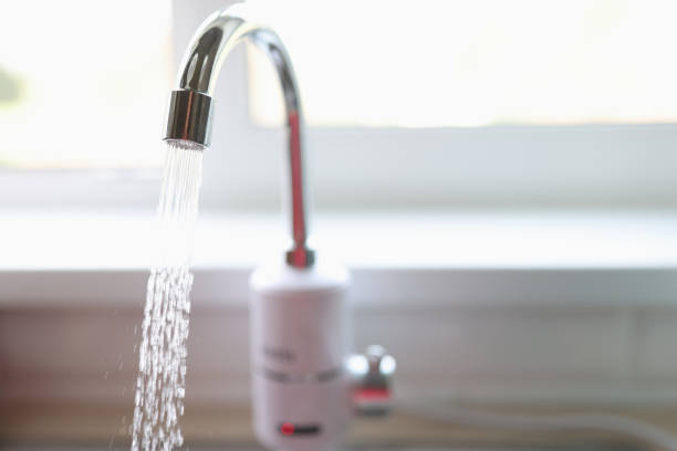 istock Pure water flows from faucet in kitchen closeup 1343467747
