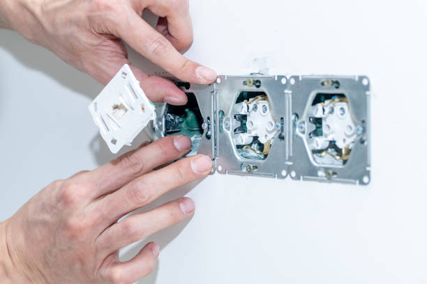 istock The craftsman installs an electrical outlet into the wall. 1343468672