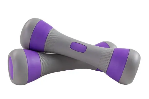 Photo of a pair of gray dumbbells with purple inserts, with a plastic cover, lie one on top of the other, on a white background