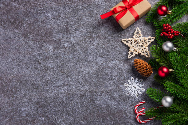 istock fir tree branches with Xmas ornaments, star and gift box 1343469872