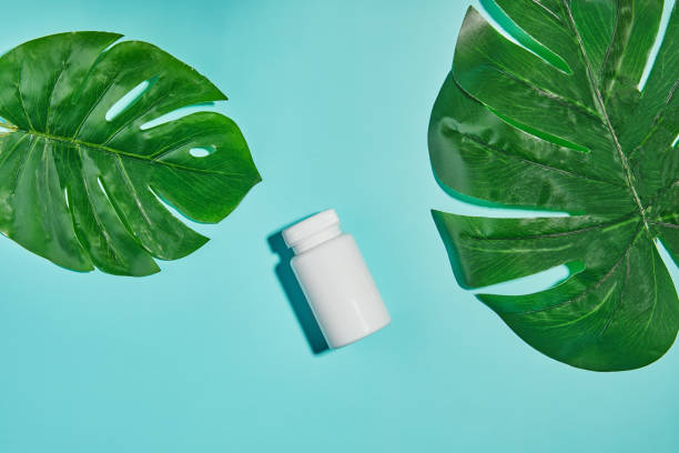 istock Jar mockup on light blue background with monstera leaves 1343470590