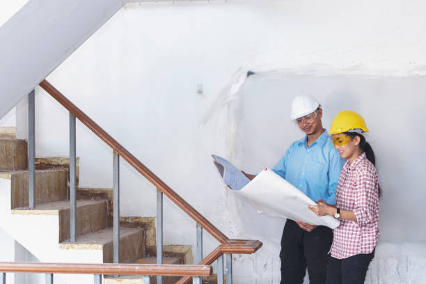 istock Construction engineer teamwork Safety Suit Trust Team Holding White Yellow Safety hard hat Security Equipment on Construction Site. Hardhat Protect Head for Civil Construction Engineer Concept 1343470951