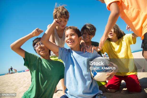 Excited Preteen Boys Patting Each Other After Game Stock Photo - Download Image Now - Child, Playful, Playing