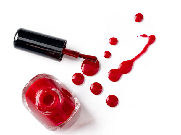 istock Bright colored nail polish bottles with drippings on white background 1343471440