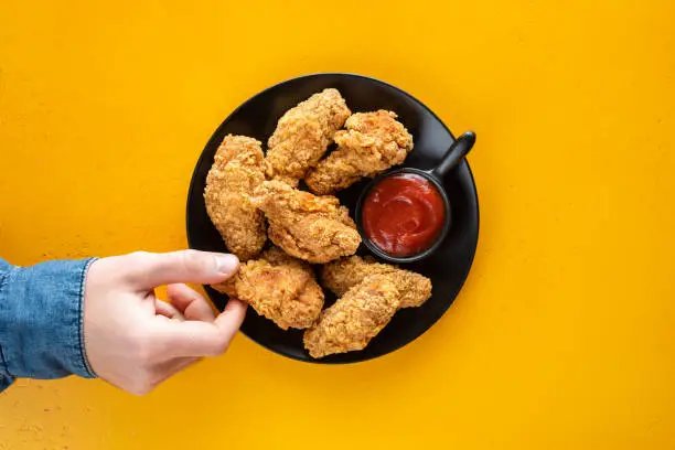 Photo of Crispy fried chicken wings with tomato sauce