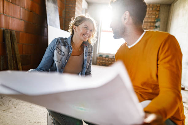 istock Happy couple talking about plans at their renovating apartment. 1343472814