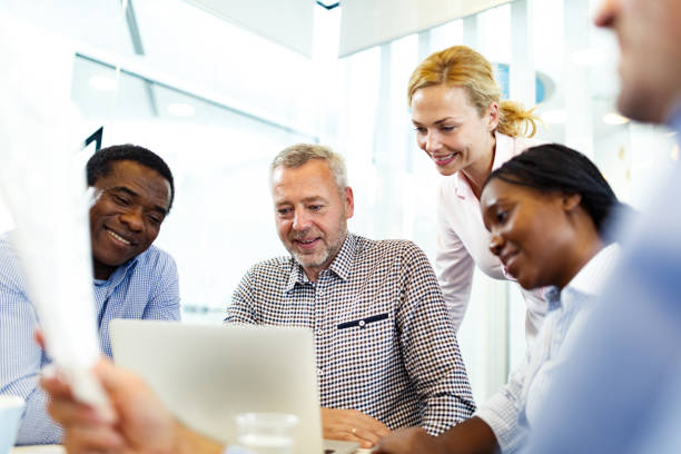 istock Happy business team reading an e-mail on laptop in the office. 1343472963