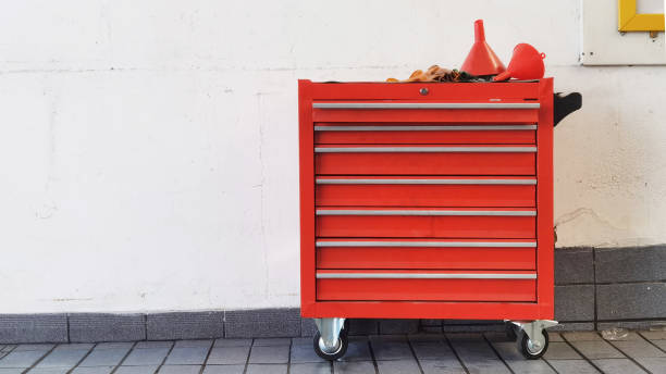 istock Red plastic oil funnel on steel locker 1343474392