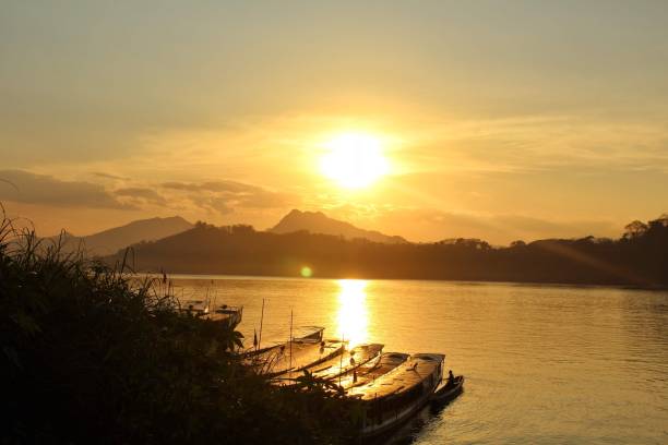 istock Sunset over the water in laos 1343474483