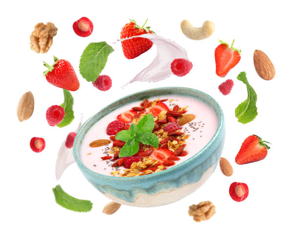 istock Delicious yogurt, granola, nuts and berries on white background 1343477235