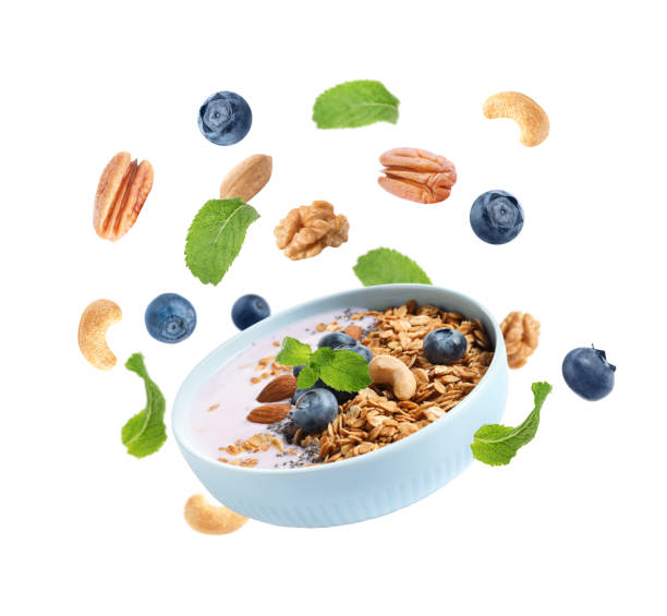 istock Delicious yogurt with blueberries, nuts and oatmeal on white background 1343477406