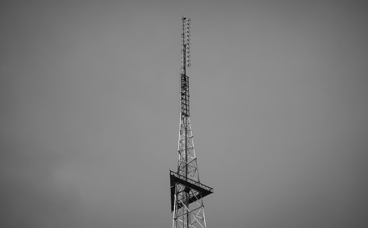Radio tower on the heights, sky on background.