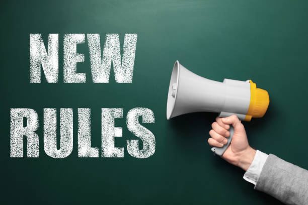istock Man holding megaphone and text NEW RULES on chalkboard, closeup 1343477716