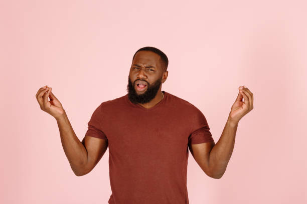 istock African-American guy actor with beard meditates on pink 1343478781