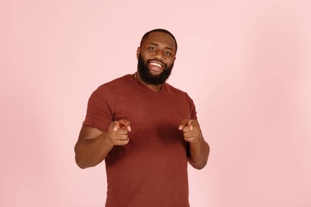 istock Cheerful African-American man points to camera with fingers 1343478813