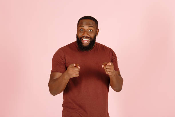 istock Cheerful African-American man points to camera with fingers 1343478835