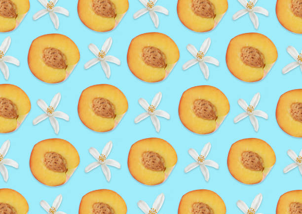 istock Pattern of citrus flowers and peach halves on light blue background 1343478908