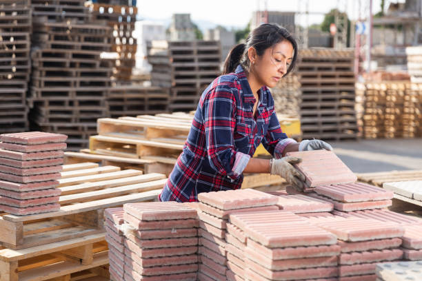 istock Latin american female stacking tiles on pallet 1343482177