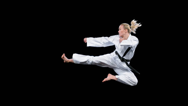 istock Female karate player performing a flying kick 1343482320