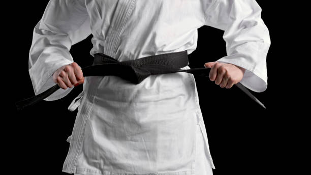 istock Male karate player standing against black background 1343482332