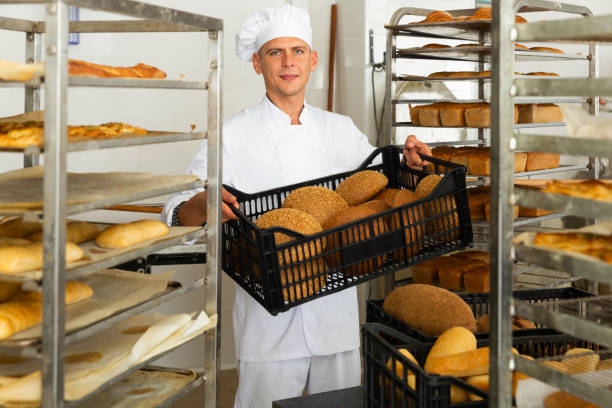 istock Male baker carrying crate with baked bread 1343484215