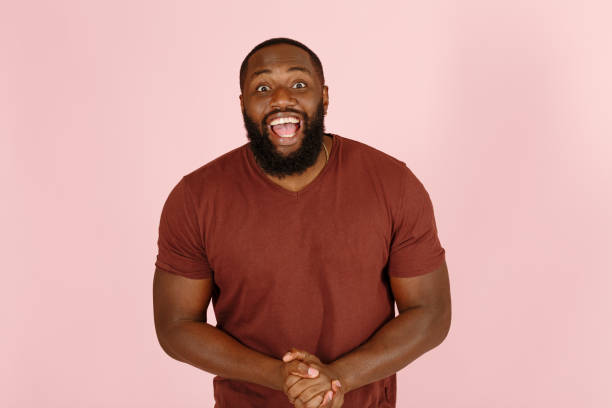 istock Broadbrow African-American man poses for camera on pink 1343486512