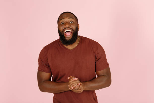 istock Broadbrow African-American man poses for camera on pink 1343486518