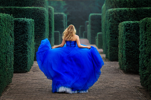 A beautiful blonde princess in a secret garden setting