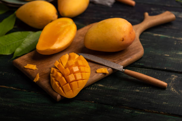 istock Cut and complete mangoes on the chopping board 1343487463