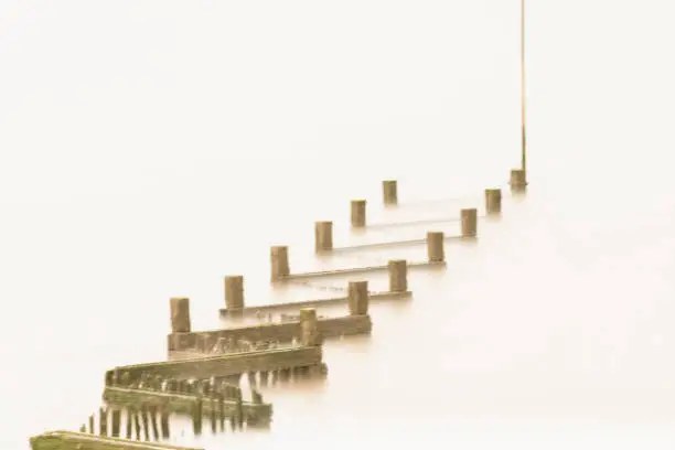 Long exposure photograph of wooden sea defences at high tide. Exposure time in excess of 60 secs