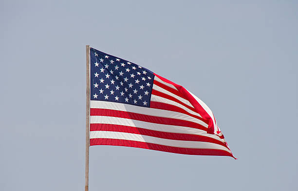 istock American Flag Blowing in Sky 134348867