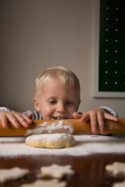 istock Little Boy Knead Christmas Cookies 1343490319