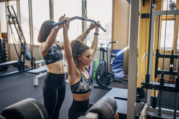 istock Personal trainer assisting a woman in training 1343490422