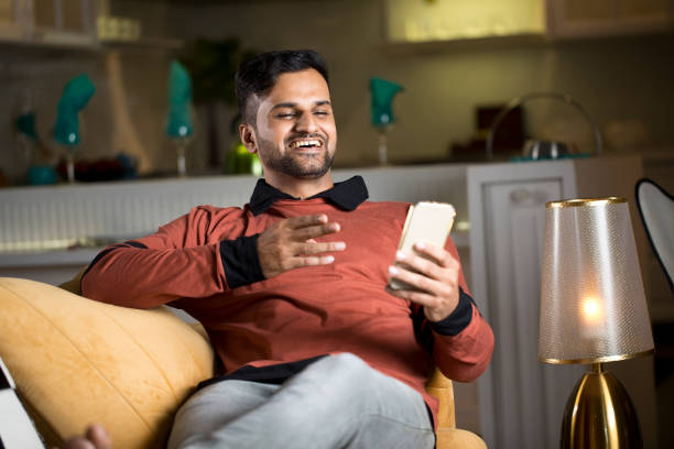 istock Man watching funny videos using mobile phone at home 1343491757