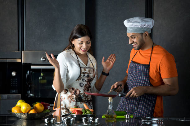 istock Couple having fun while cooking food in kitchen 1343491851