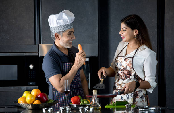 istock Couple having fun while cooking food in kitchen 1343491992