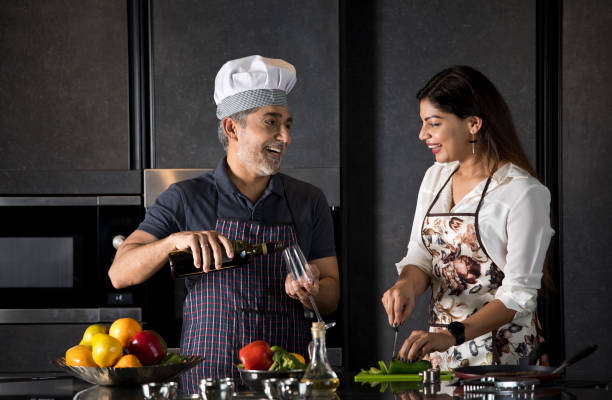 istock Happy couple enjoying champagne while cooking food in kitchen 1343492021