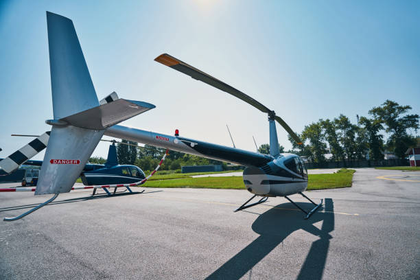 istock Two civilian helicopters standing on concrete landing pad 1343492084
