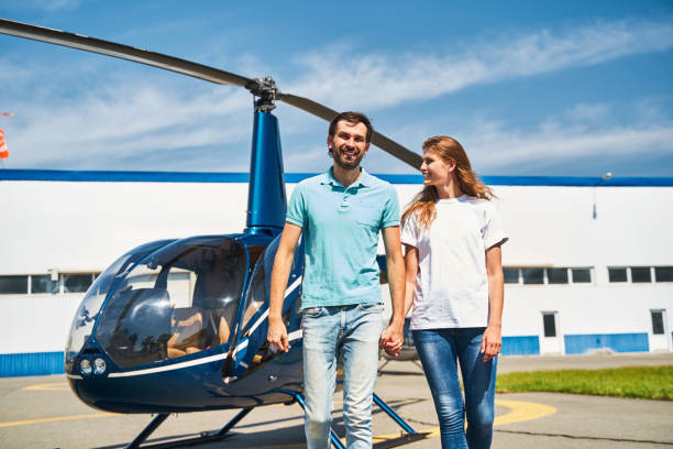 istock Joyous romantic couple walking across the helipad 1343492085